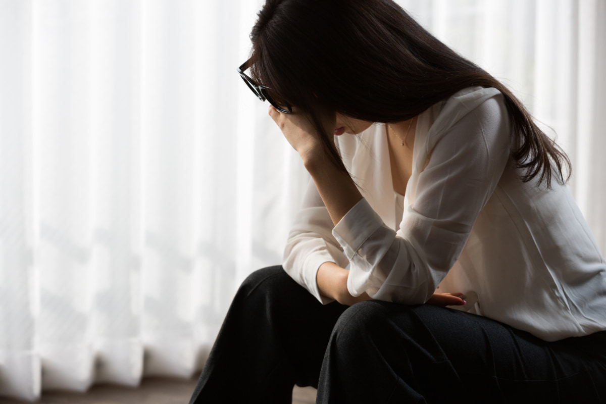 入れ歯で失敗して頭をかかえる女性